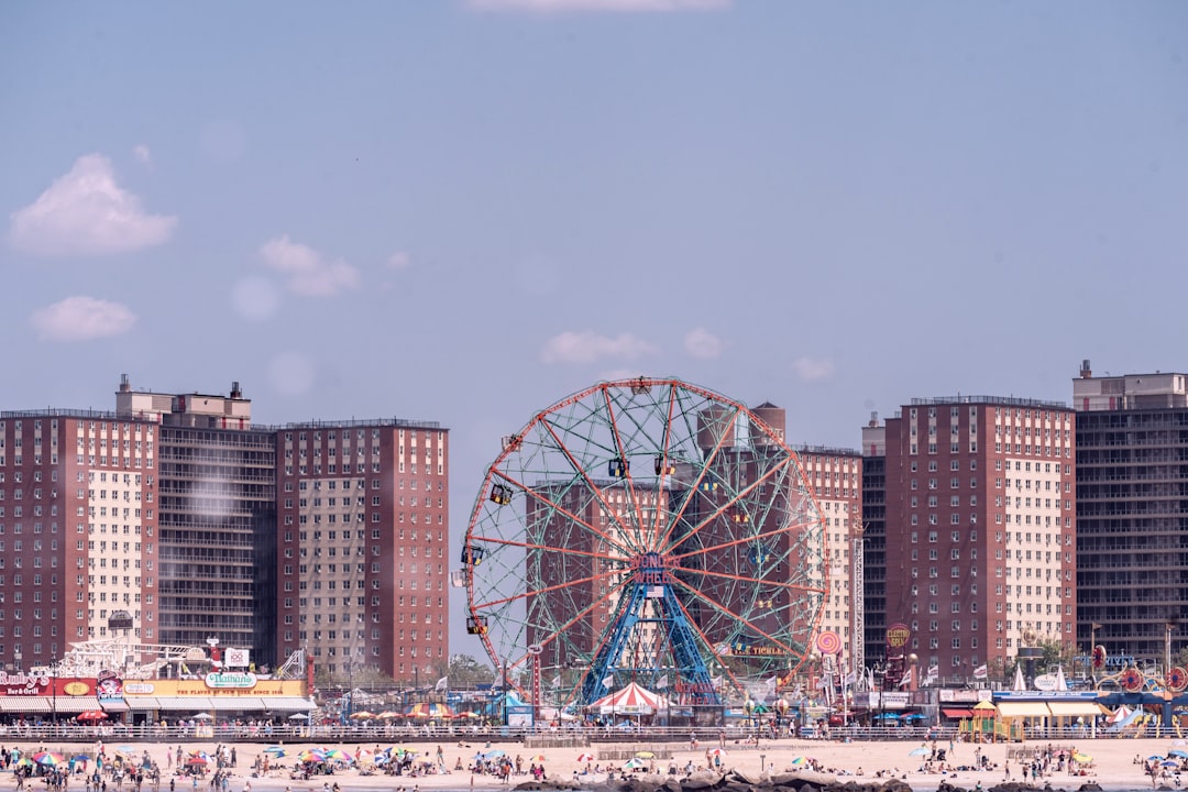 ferris wheel near city buildings during daytime