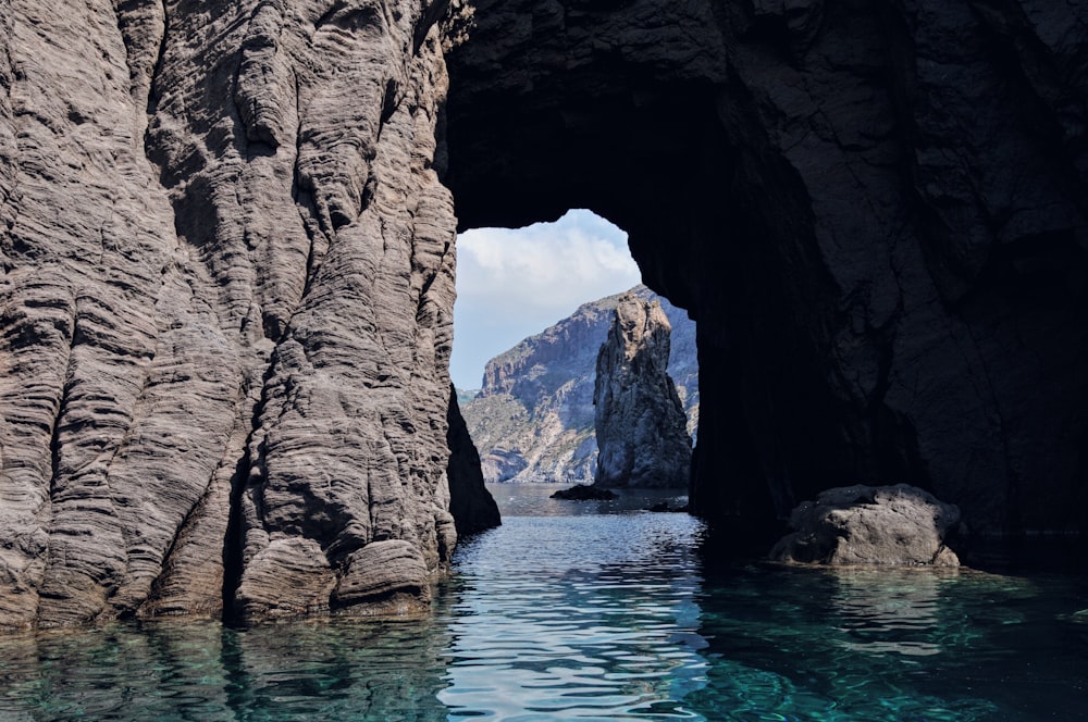 brown rock formation on blue water during daytime