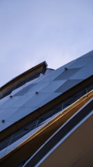 A sleek modern building with clean lines and warm natural light highlighting its architectural details.