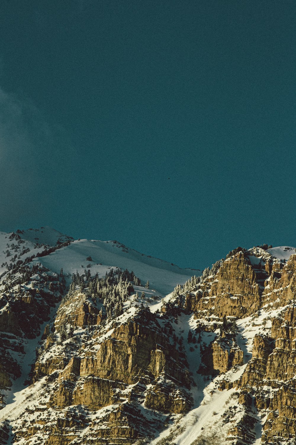 snow covered mountain under blue sky during daytime