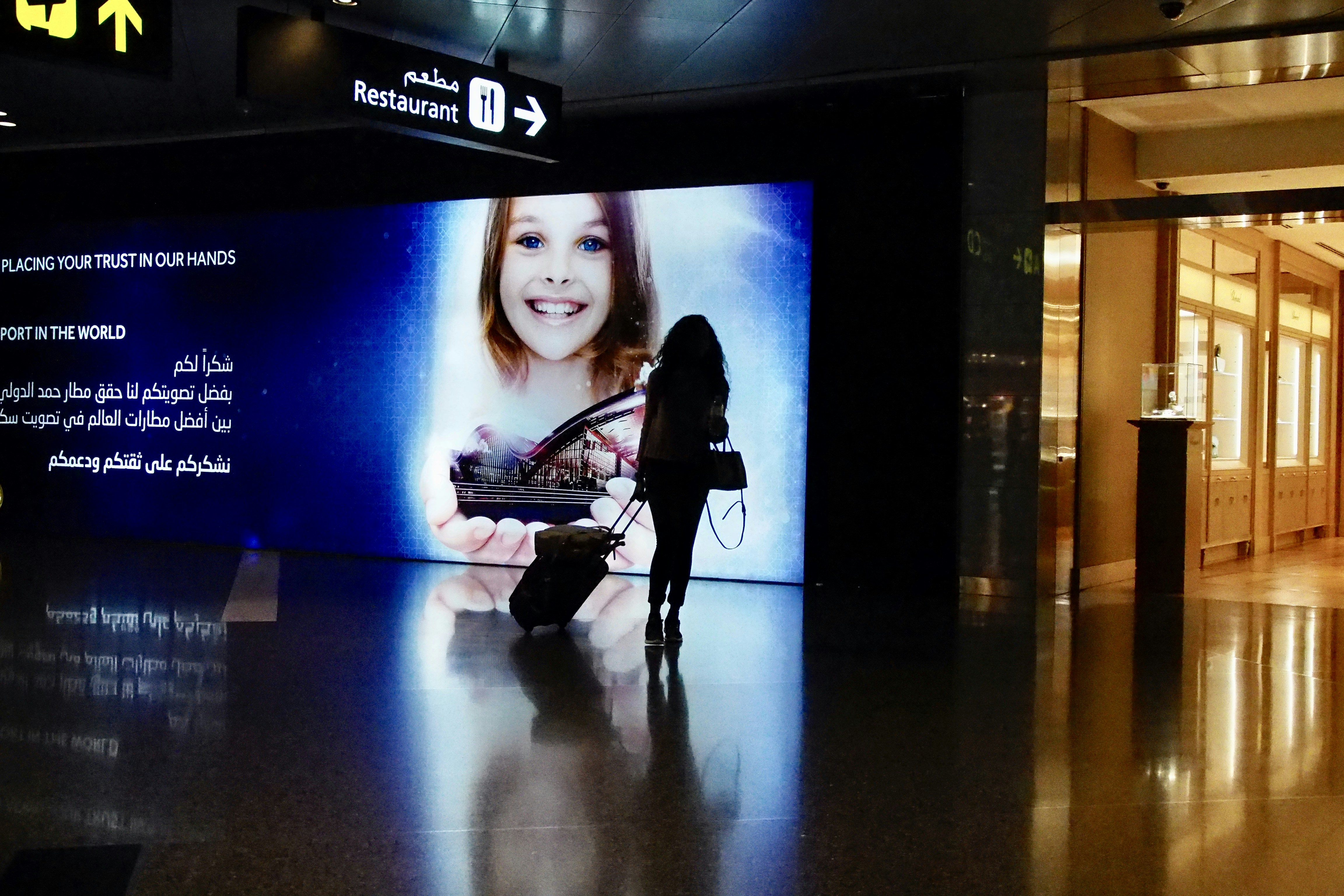 woman in black long sleeve shirt and black pants holding black and white electric guitar, 