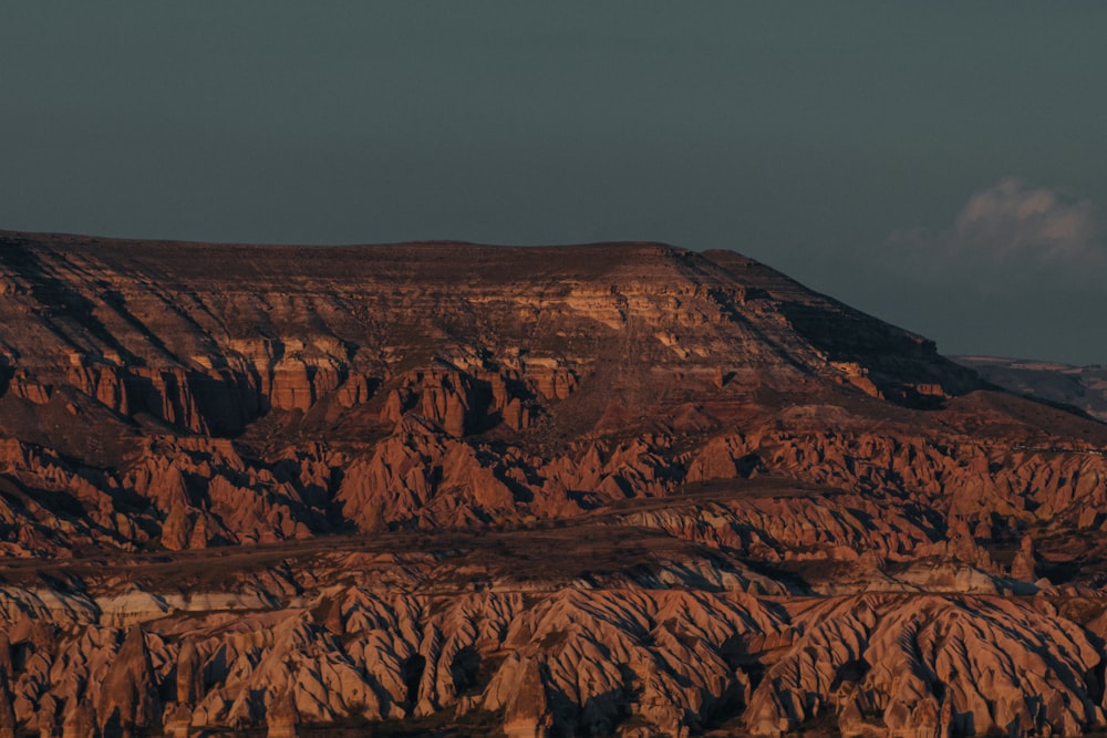 brown rock formation under gray sky during daytime