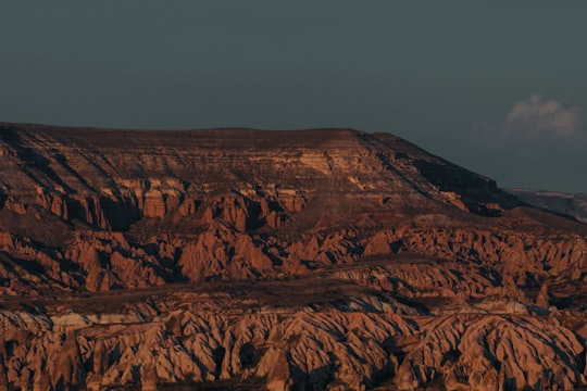 brown rock formation under gray sky during daytime in Cappadocia Turkey