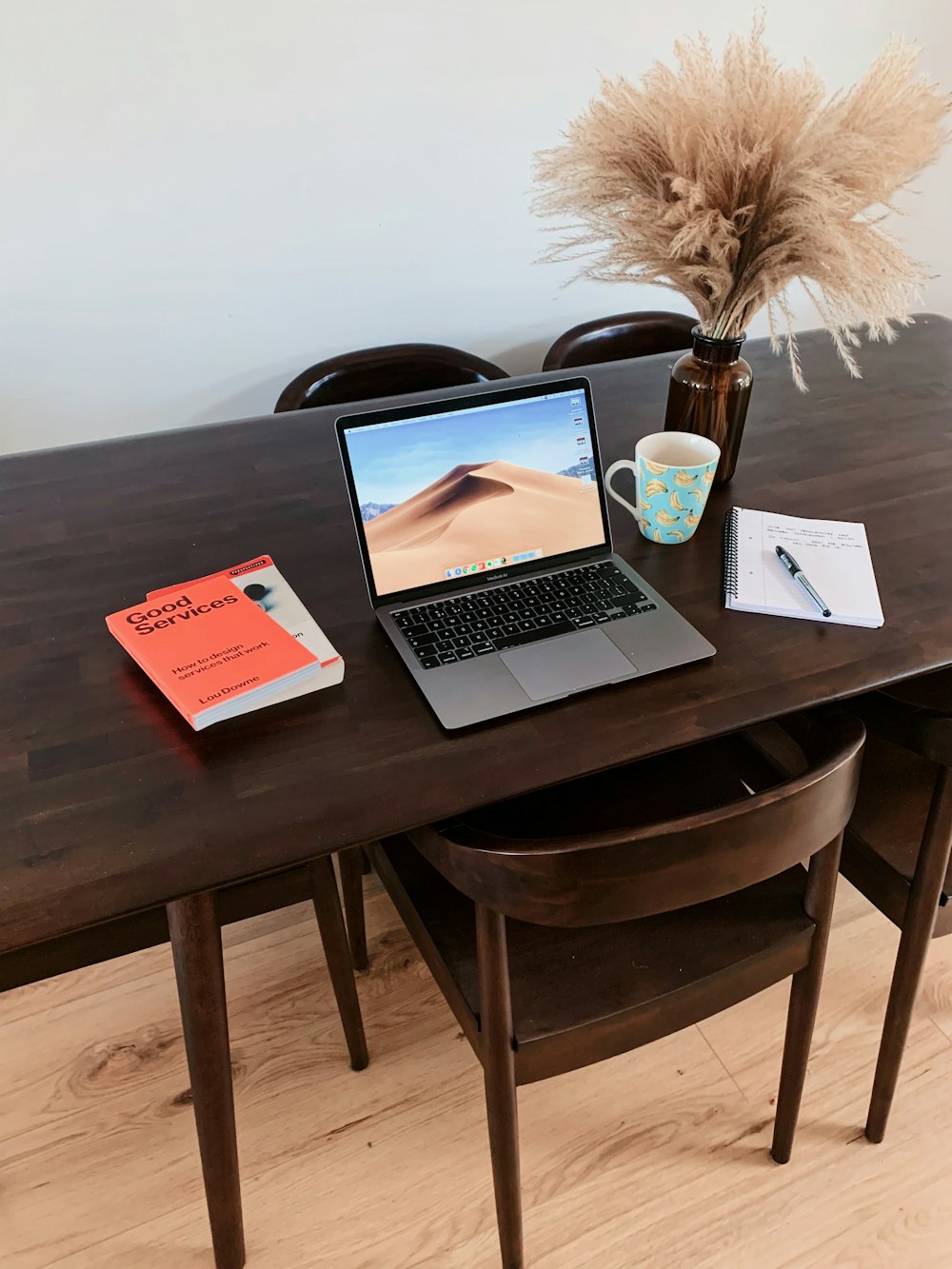 macbook pro on brown wooden table