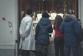 Friendly staff carefully evaluating gold jewelry in a bright, modern Staten Island store.