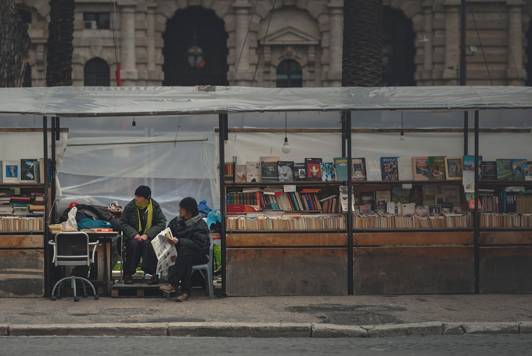 people sitting on bench near store during daytime