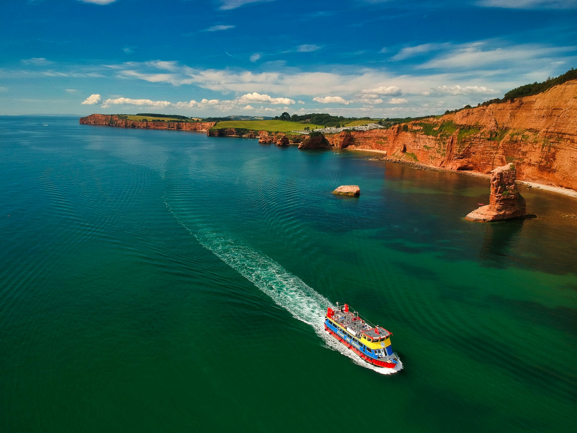 white and red boat on sea during daytime