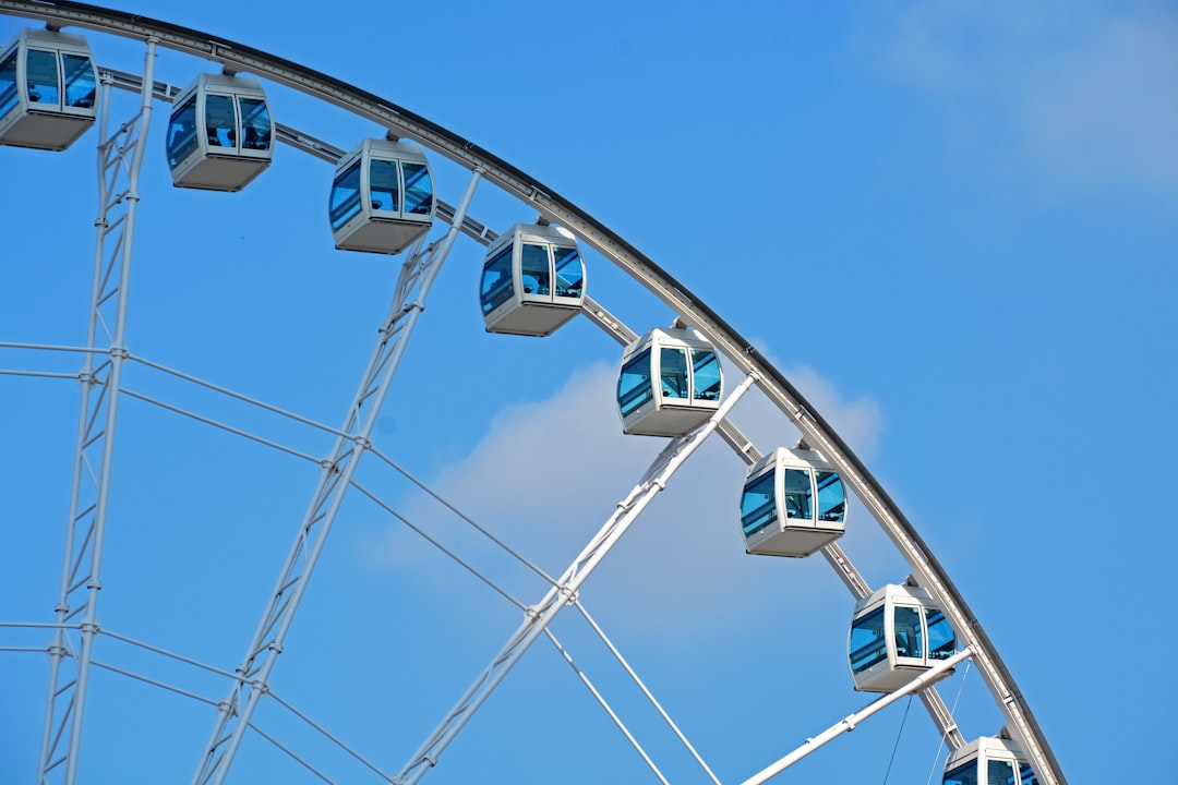 white and blue ferris wheel under blue sky during daytime