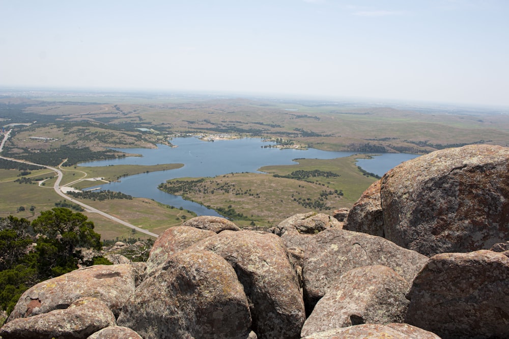 brown rocky mountain near green grass field during daytime