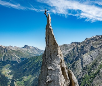 person standing on rock formation during daytime