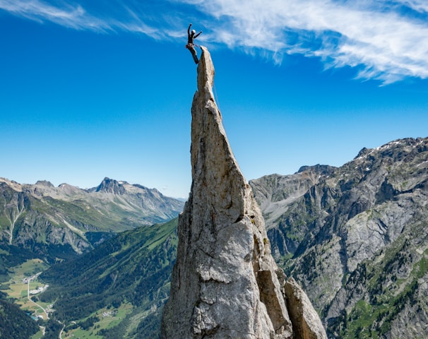 person standing on rock formation during daytime