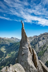 person standing on rock formation during daytime