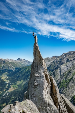 person standing on rock formation during daytime