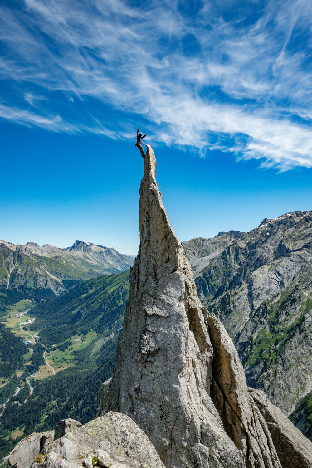 Persona in piedi sulla formazione rocciosa durante il giorno