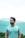 man in teal crew neck shirt wearing black framed eyeglasses