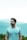 man in teal crew neck shirt wearing black framed eyeglasses