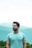 man in teal crew neck shirt wearing black framed eyeglasses