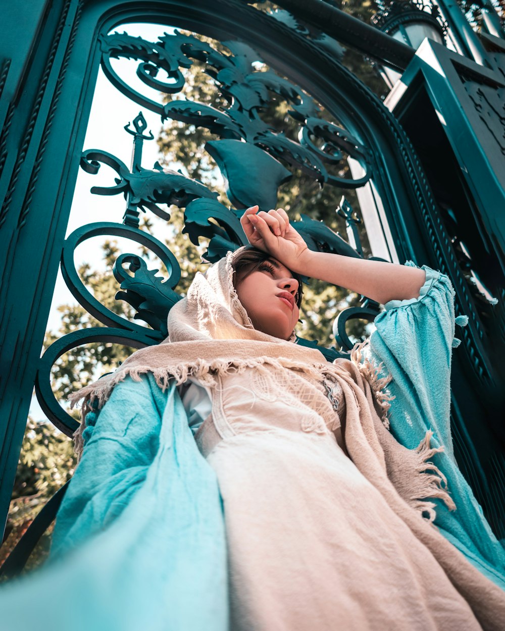 girl in white dress lying on blue hammock