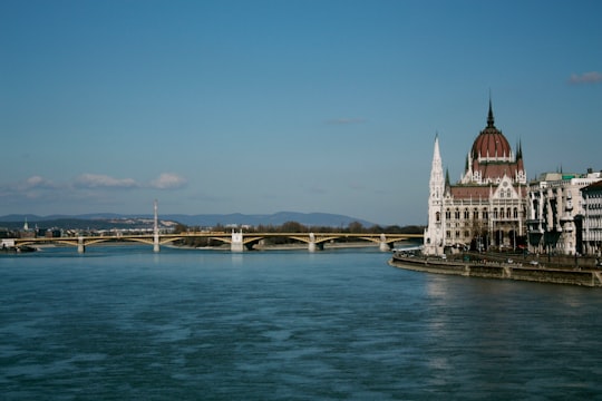 white and brown concrete building near body of water during daytime in Hungarian Parliament Building Hungary