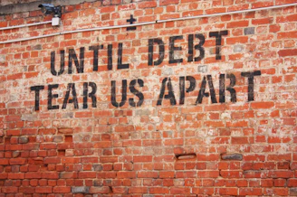 a brick wall with a message written on it