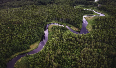 Aerial view of a river winding through lush Brazilian forest