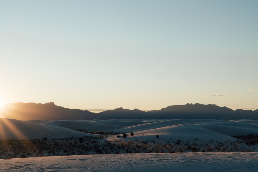 white and brown mountains near body of water during daytime