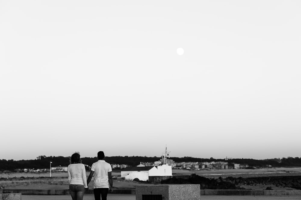 grayscale photo of people standing on the field