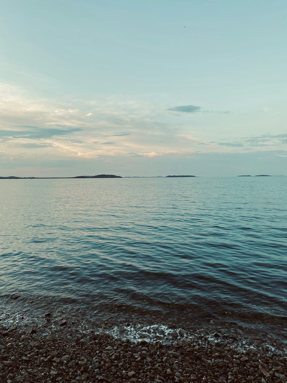 body of water under cloudy sky during daytime