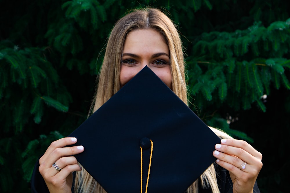 woman covering her face with blue paper