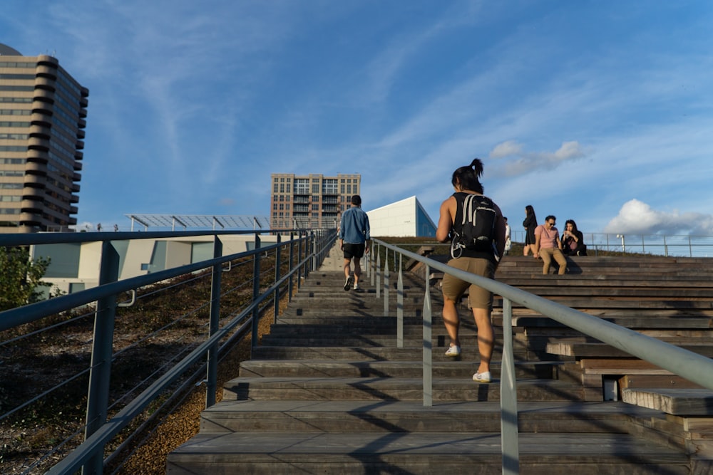 people walking on the bridge during daytime