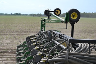 green metal wheel on green grass field during daytime