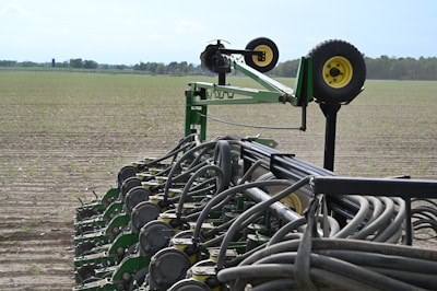 green metal wheel on green grass field during daytime