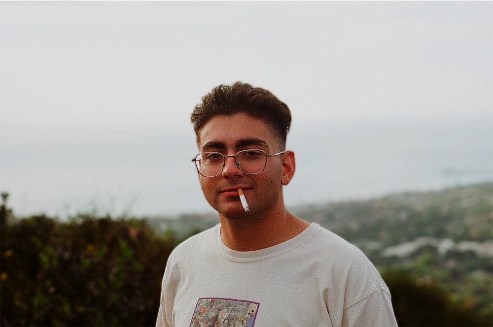 man in white crew neck shirt wearing eyeglasses