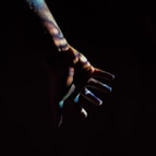 persons hand with black background