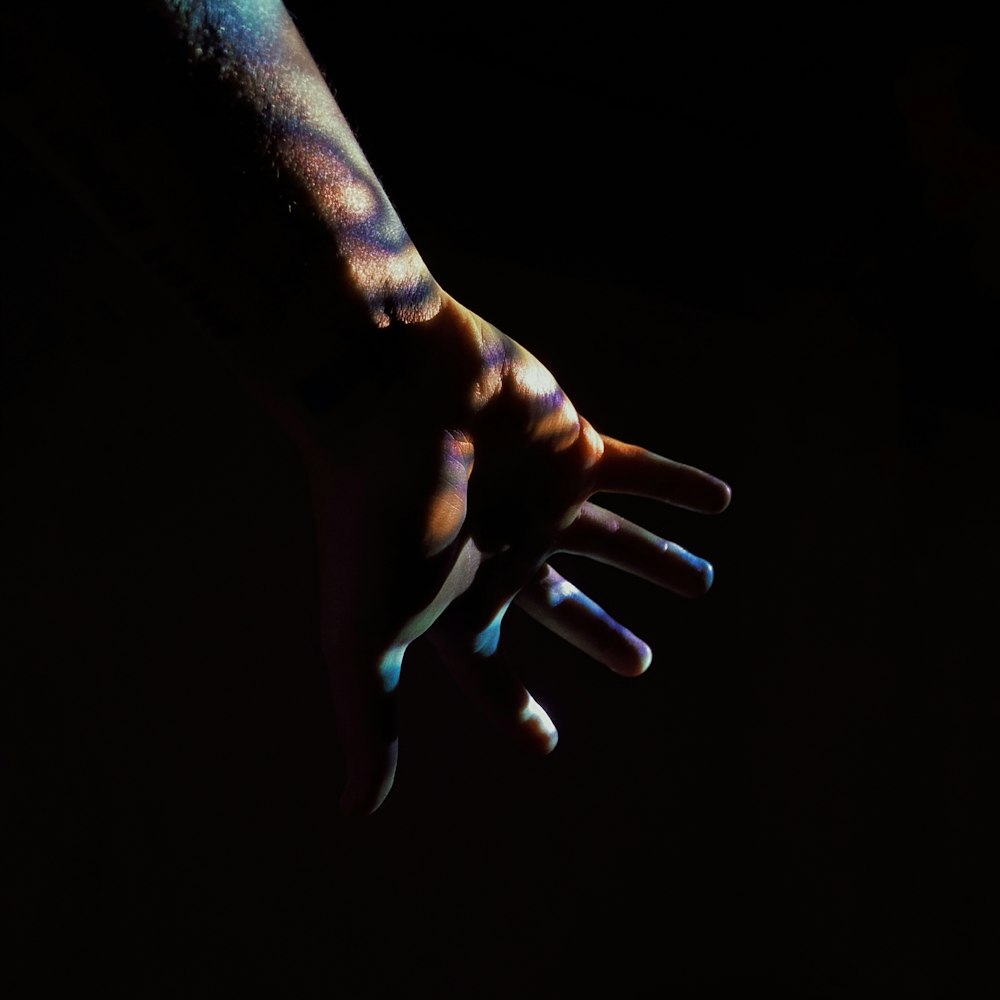 persons hand with black background