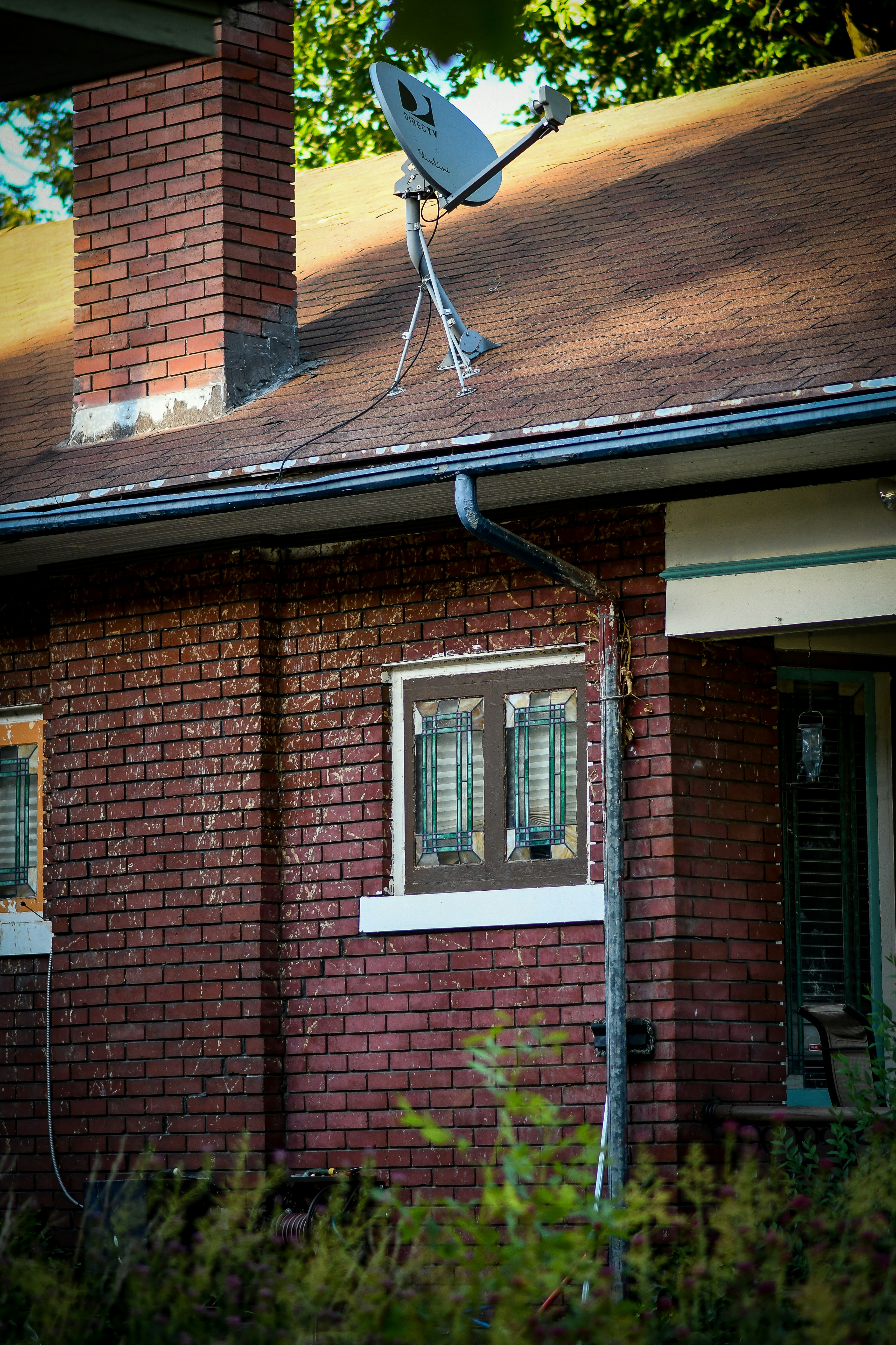 brown brick house with white wooden window