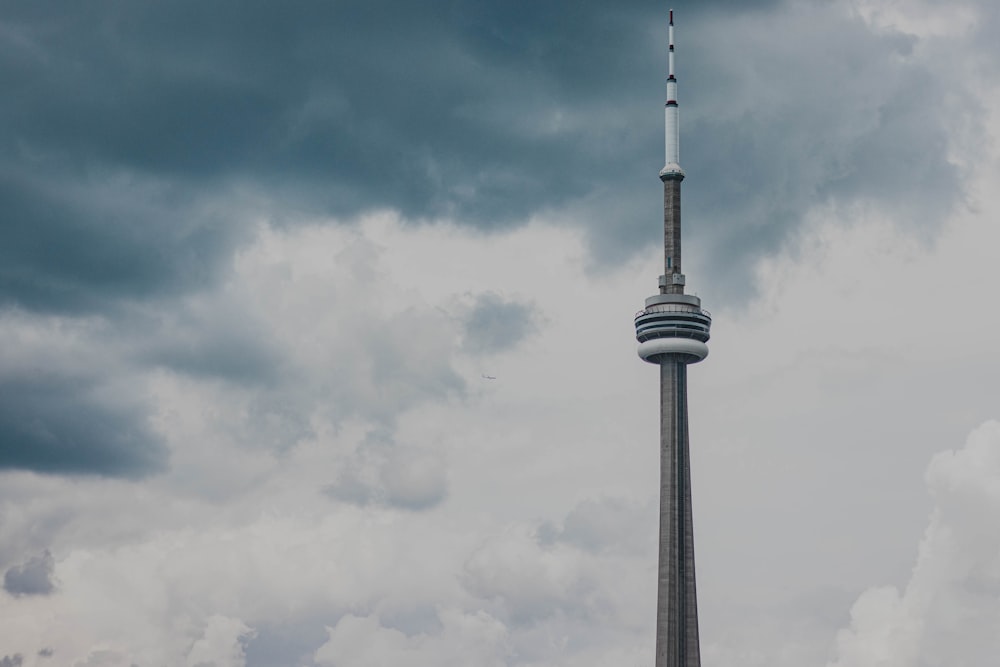 black and white tower under white clouds