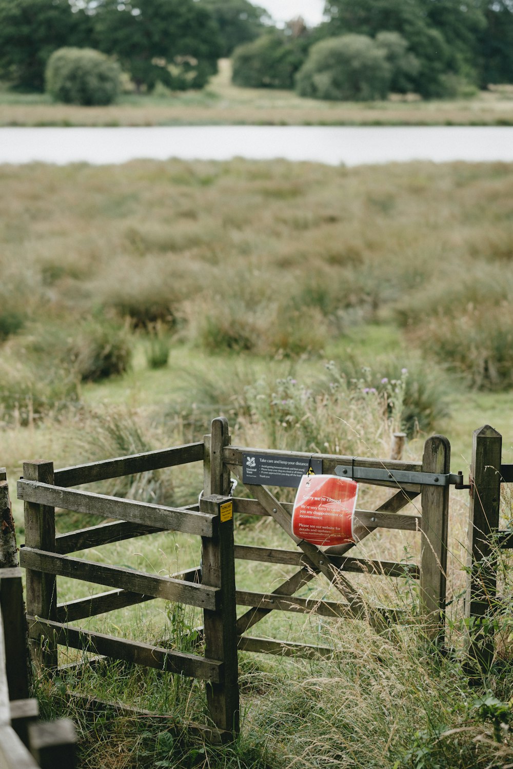 red plastic bucket on wooden fence