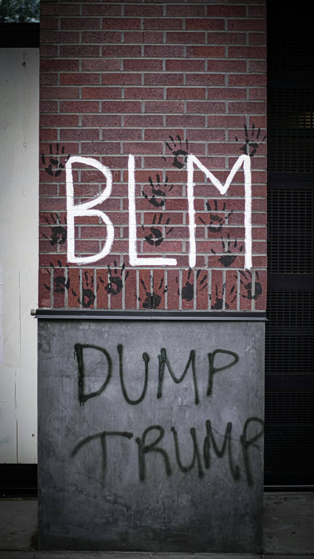 a brick wall with graffiti written on it