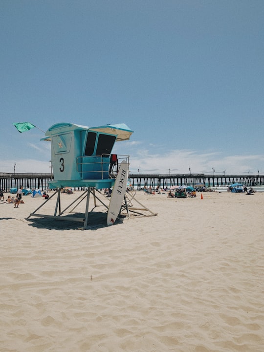 green and brown wooden lifeguard house on beach during daytime in Pismo State Beach United States
