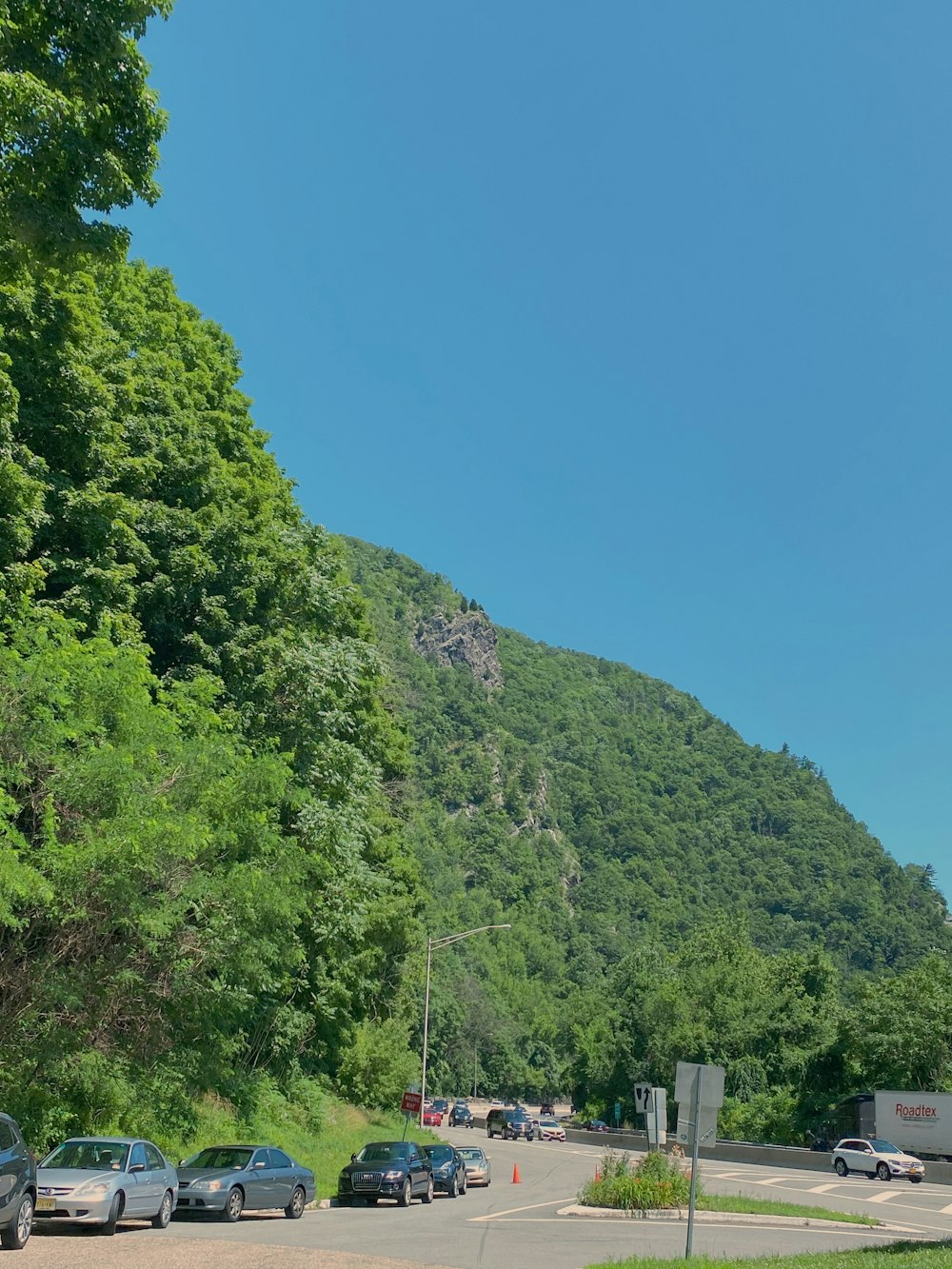 green trees on mountain under blue sky during daytime