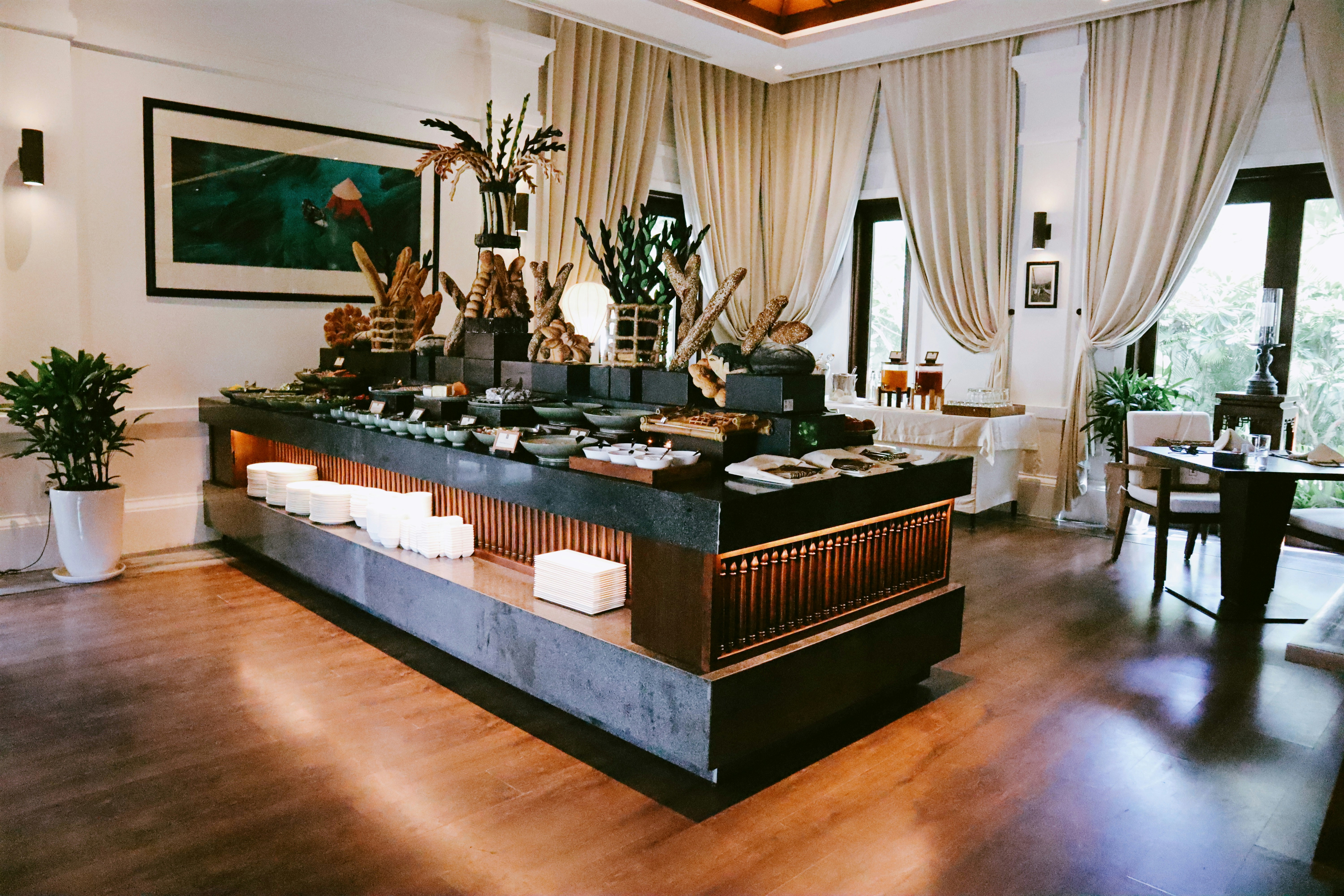 Large event catering buffet with abundant food spread, well-lit professional event venue