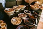 A colorful display of assorted dried fruits and nuts on a wooden table.