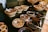 A vibrant display of assorted seeds, dry fruits, and spices arranged neatly on a wooden table.
