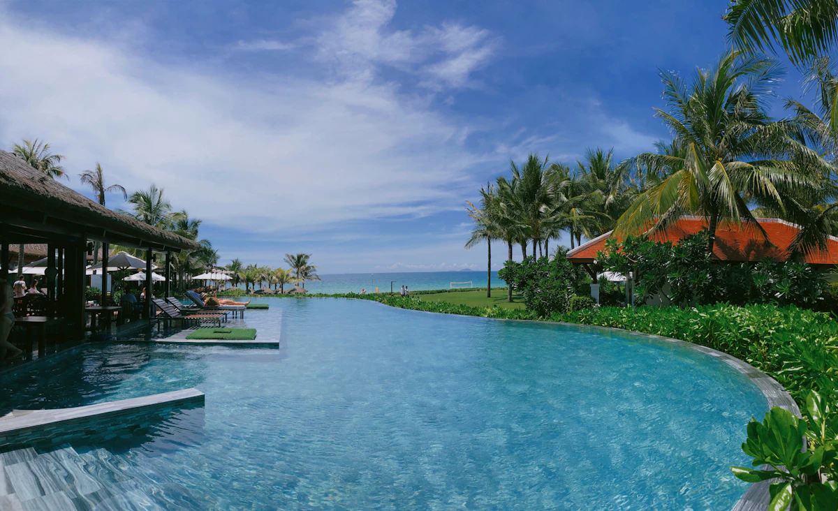 Luxury boutique resort pool in Hoi An overlooking tropical gardens