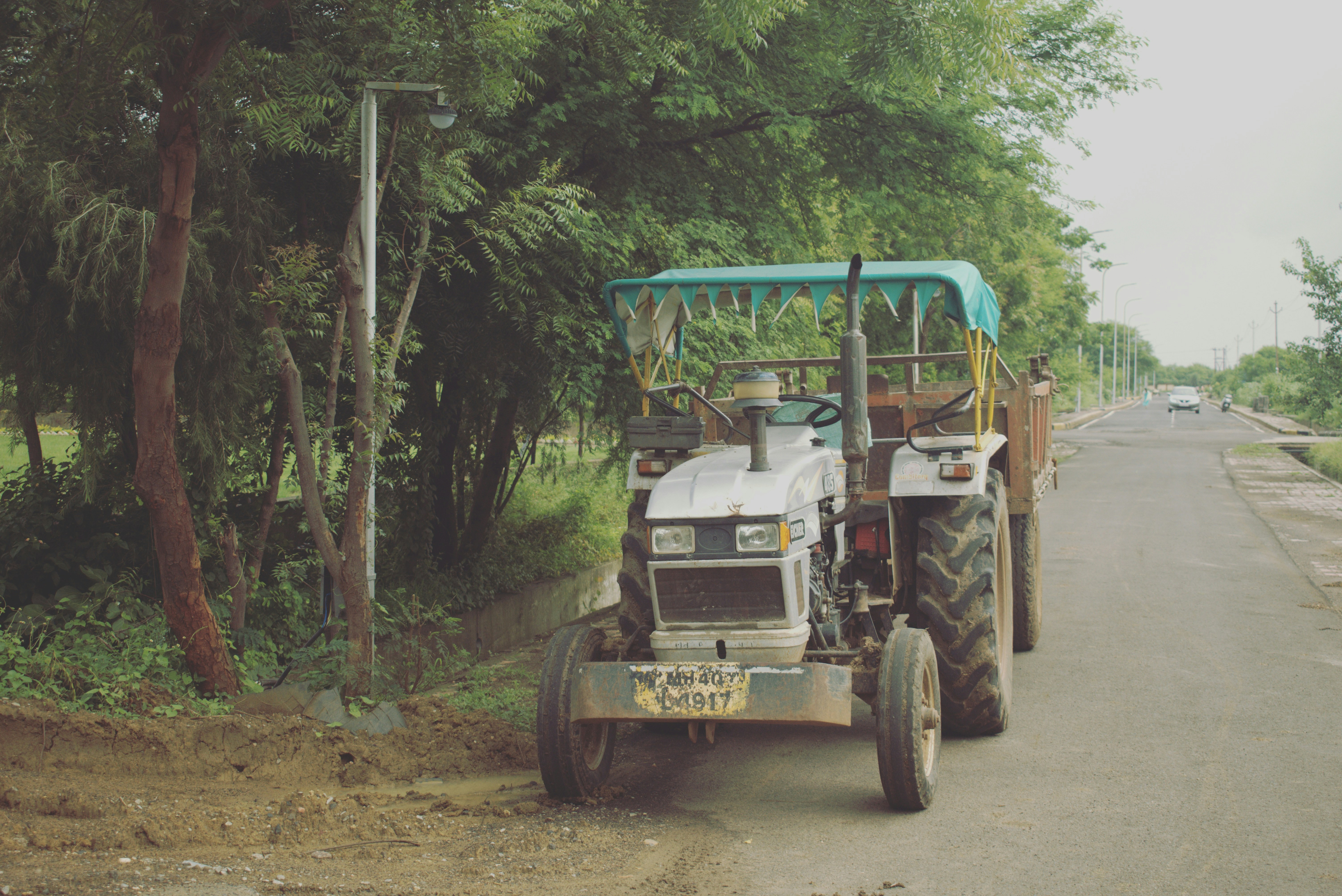 white and black atv on dirt road during daytime