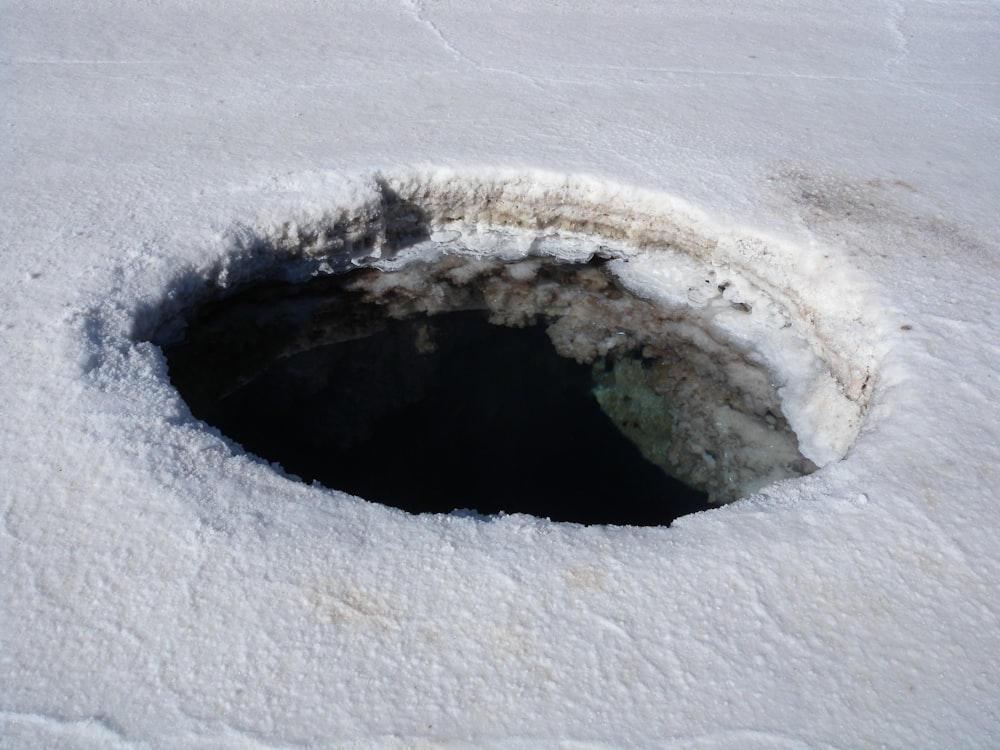 brown and white round hole on white sand