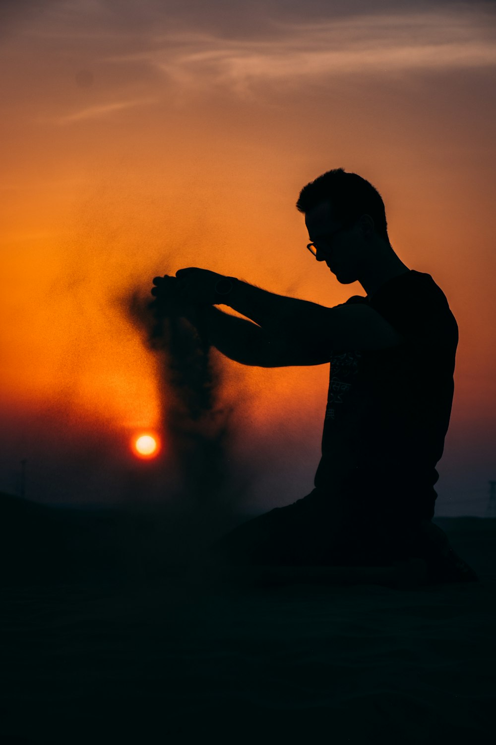 silhouette of man smoking during night time