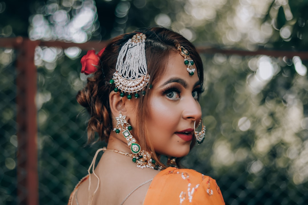 woman in orange and white floral dress wearing gold crown