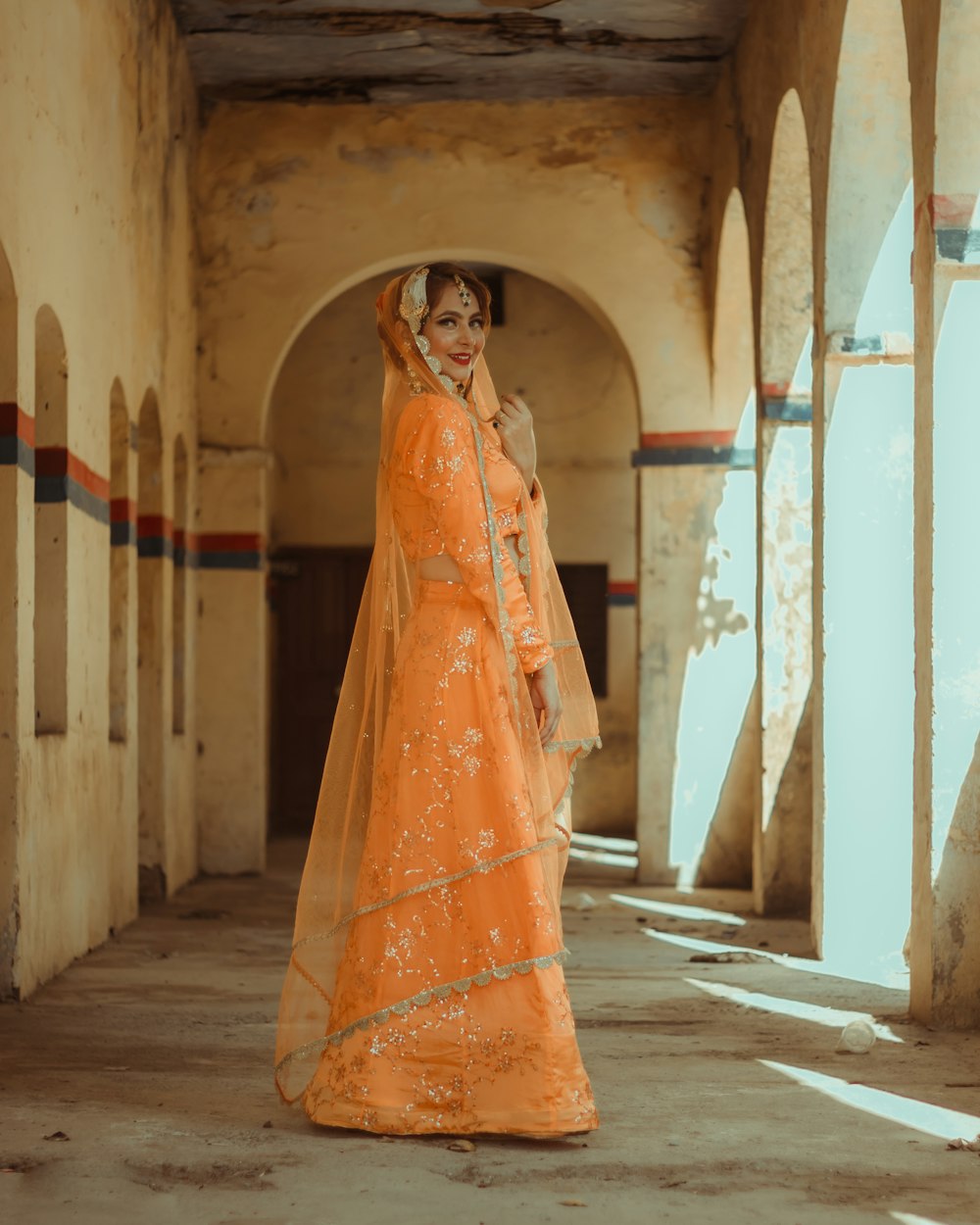 woman in yellow dress standing on gray concrete floor during daytime